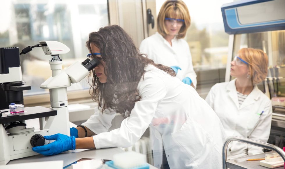 photo-of-real-female-scientist-looking-into-a-micr-2023-11-27-04-55-39-utc